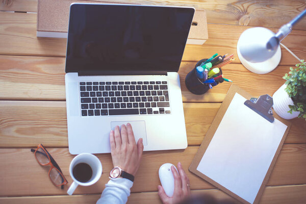 Young female working sitting at a desk.
