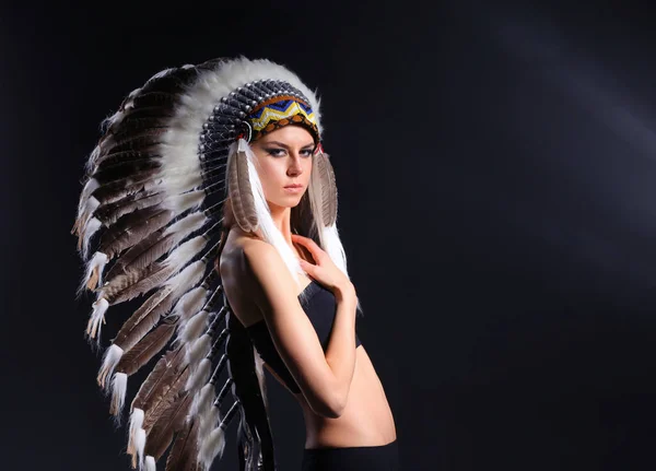 Beautiful woman in native american costume with feathers. Beautiful woman