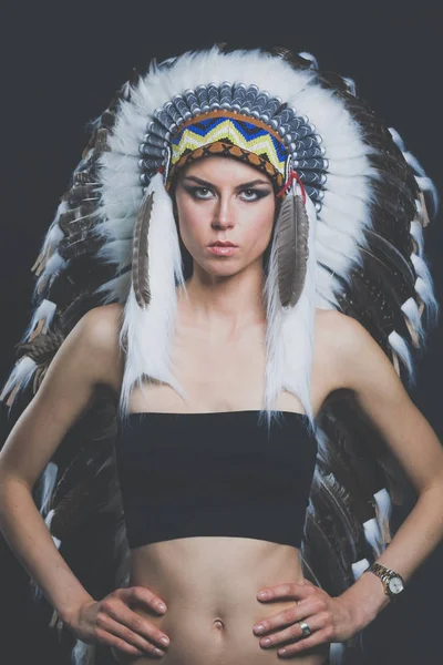 Beautiful woman in native american costume with feathers. Beautiful woman