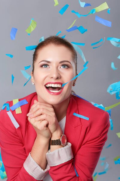 Beautiful happy woman at celebration party with confetti .Birthday or New Year eve celebrating concept