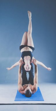 Genç çift Acro yoga mat Studio birlikte uygulamak. Acroyoga. Çift yoga. Ortak yoga.