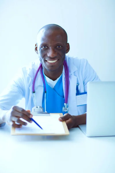 Klinikteki masada bilgisayar kullanırken kulaklık takan genç bir doktorun portresi. Doktor.. — Stok fotoğraf