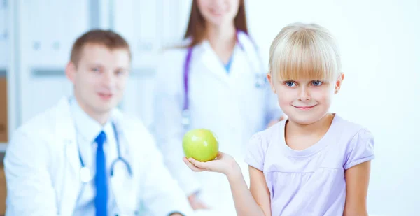 Female doctor examining child with stethoscope at surgery — Stock Photo, Image