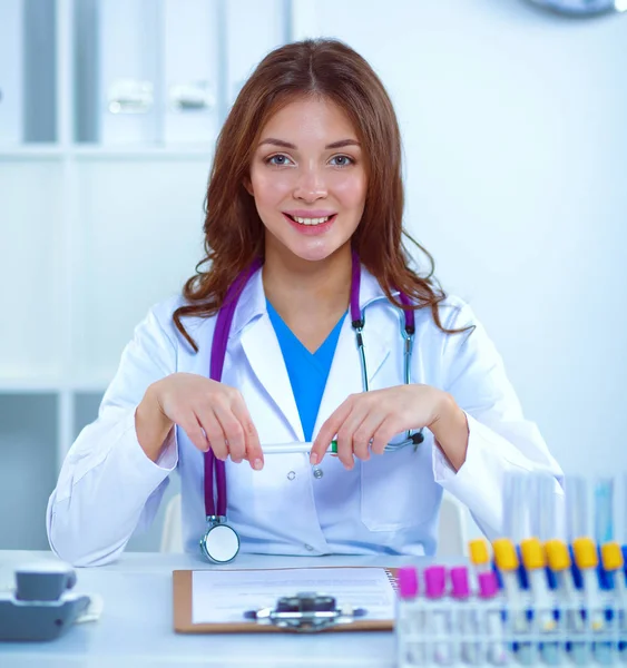 Woman researcher is surrounded by medical vials and flasks, isolated on white background — Stock Photo, Image