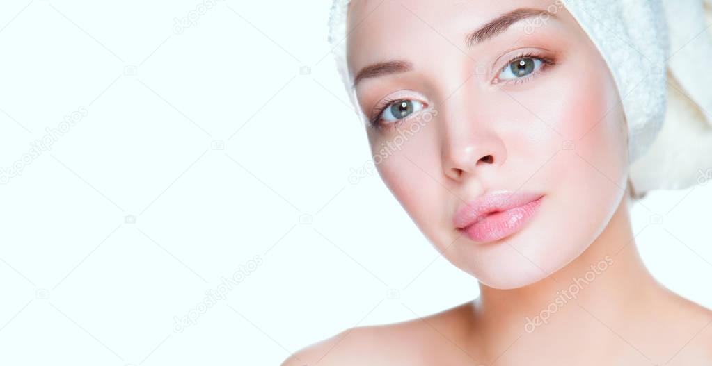 Portrait of beautiful girl touching her face with a towel on head