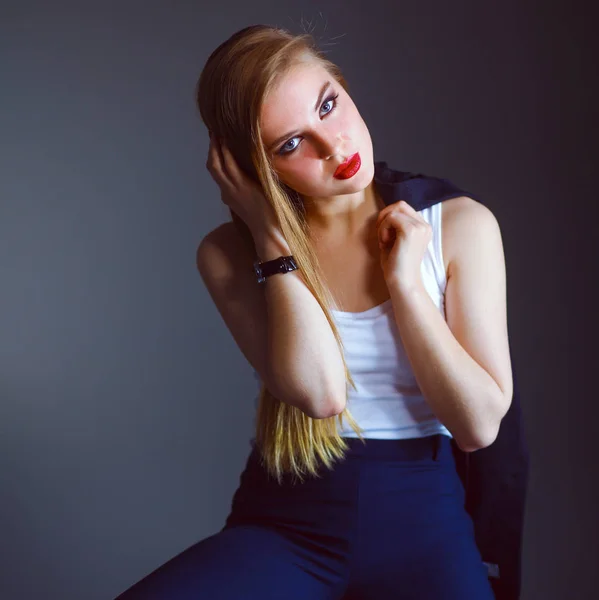 Young woman sitting on a chair — Stock Photo, Image