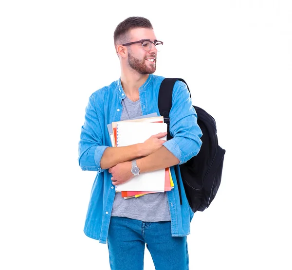 Un estudiante masculino con una bolsa de la escuela sosteniendo libros aislados sobre fondo blanco — Foto de Stock