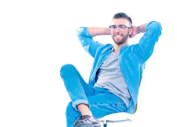 Young man sitting on the chair isolated over white background — Stock Photo, Image