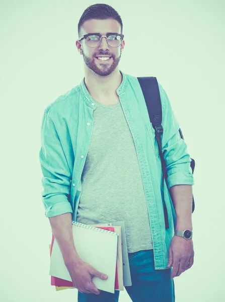 En manlig student med en väska håller böcker isolerad på vit bakgrund — Stockfoto