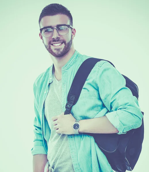 Un estudiante masculino con una bolsa de la escuela sosteniendo libros aislados sobre fondo blanco —  Fotos de Stock