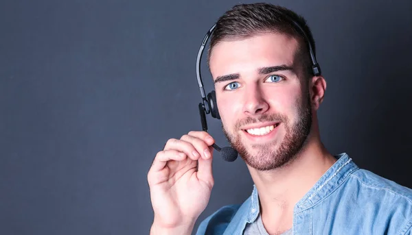 Portrait of young male with microphone standing on gray background — Stock Photo, Image