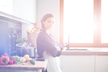 Mutfakta masada oturan genç kadın.