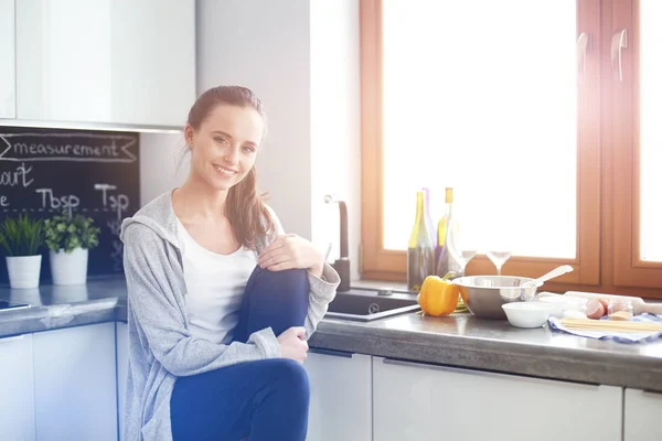 Woman in the kitchen. Cooking at kitchen.