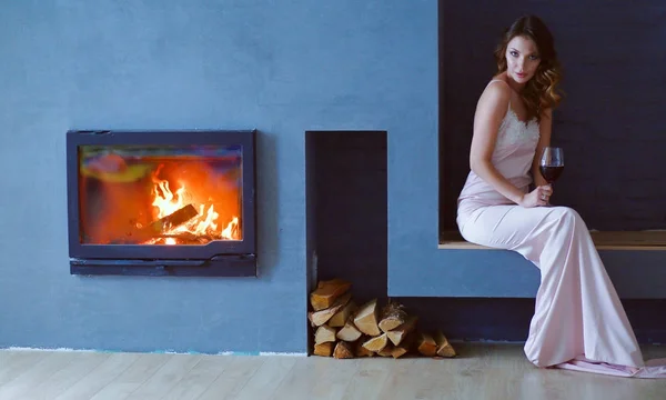 Mujer sexy frente a la chimenea. Chimenea de madera . —  Fotos de Stock