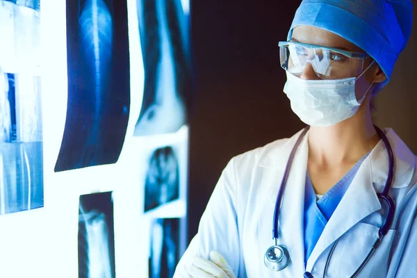 Image of attractive woman doctor looking at x-ray results. — Stock Photo, Image