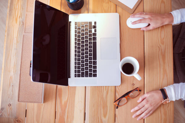 Young female working sitting at a desk.