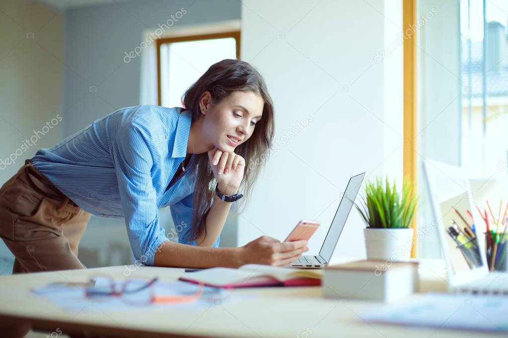 Young female working sitting at a desk. Businesswoman. Drawing. Student. Workplace. Desk.