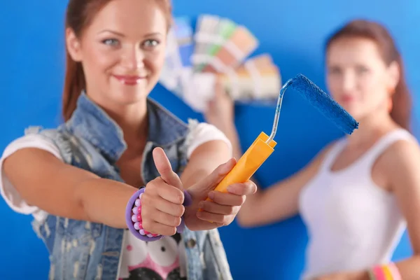 Dos hermosas mujeres jóvenes pintando paredes. Dos Hermosa joven mujer —  Fotos de Stock