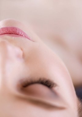 Masaj masasında uzanmış gözleri kapalı rahatlayan genç bir kadın. - Kadın. Spa salonu