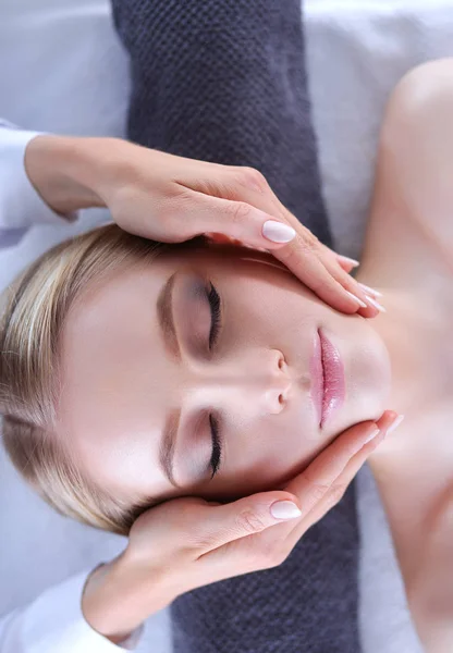 Young woman lying on a massage table,relaxing with eyes closed. Woman. Spa salon — Stock Photo, Image