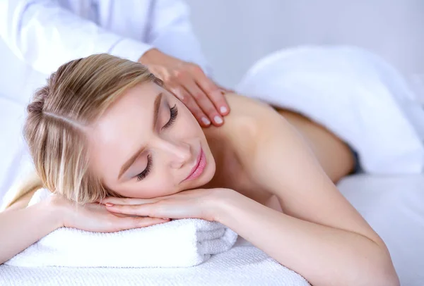 Young woman lying on a massage table,relaxing with eyes closed. Woman. Spa salon — Stock Photo, Image