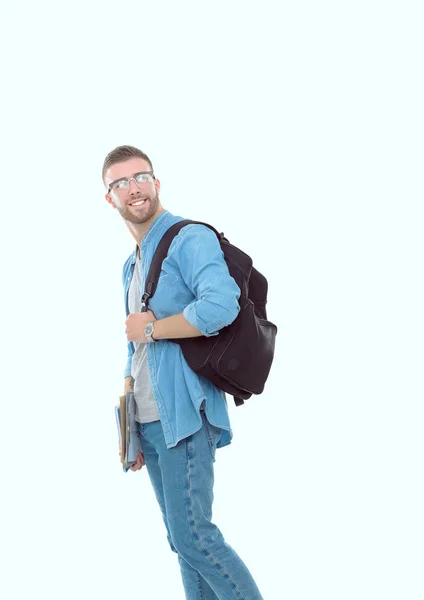 Beyaz arka plan üzerinde izole kitap tutan bir okul çantası ile bir erkek öğrenci. Eğitim olanakları. Üniversite öğrencisi. — Stok fotoğraf