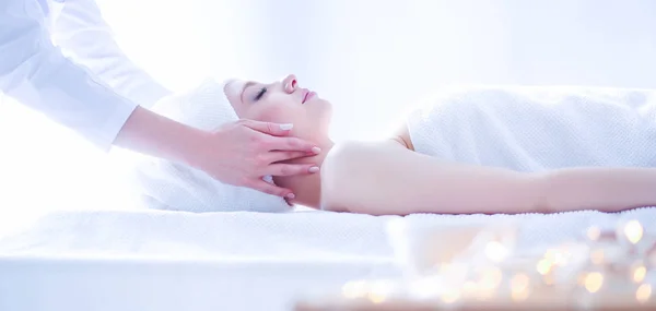 Young woman lying on a massage table,relaxing with eyes closed — Stock Photo, Image