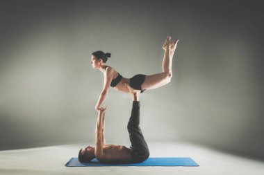 Genç çift Acro yoga mat Studio birlikte uygulamak. Acroyoga. Çift yoga. Ortak yoga.