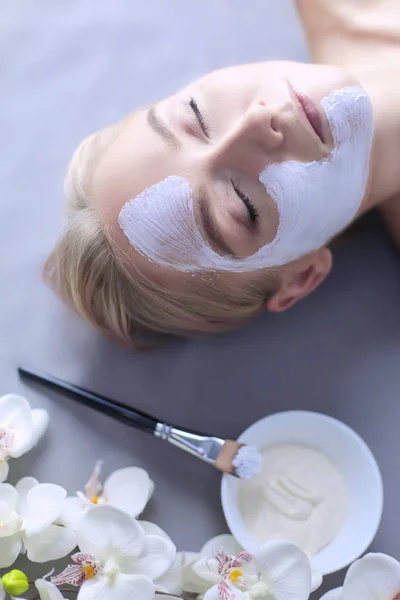 Ansiktsmask. Vacker ung flicka på spa, cosmetician kvinna tillämpa ansiktsmask — Stockfoto