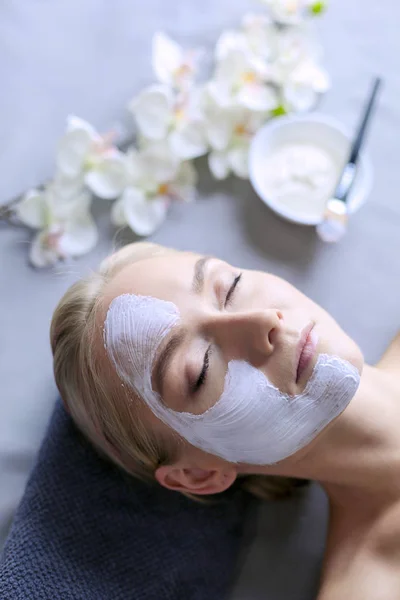 Mascarilla facial. Hermosa joven en el spa, mujer cosmética aplicando mascarilla facial —  Fotos de Stock