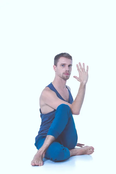 Adult man with naked torso doing exercise on white background — Stock Photo, Image