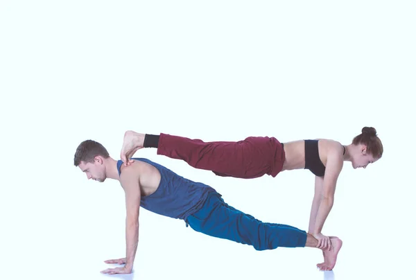 Young athletic couple practicing acroyoga. Balancing in pair — Stock Photo, Image