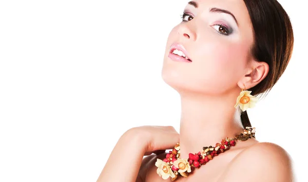 Portrait of young beautiful brunette woman in beads — Stock Photo, Image