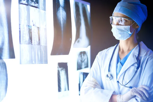 Image of attractive woman doctor looking at x-ray results. — Stock Photo, Image