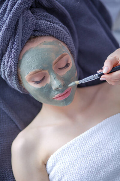 Beautiful woman having mask , lying on spa . Woman. Spa salon