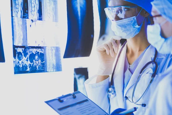 Two female women medical doctors looking at x-rays in a hospital. — Stock Photo, Image