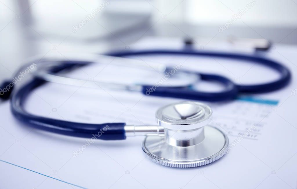 Medical equipment: blue stethoscope and tablet on white background. Medical equipment