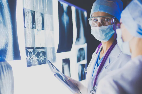 Two female women medical doctors looking at x-rays in a hospital. — Stock Photo, Image