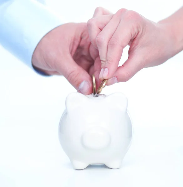 People putting coin into the piggy bank — Stock Photo, Image