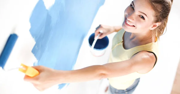 Beautiful young woman doing wall painting — Stock Photo, Image