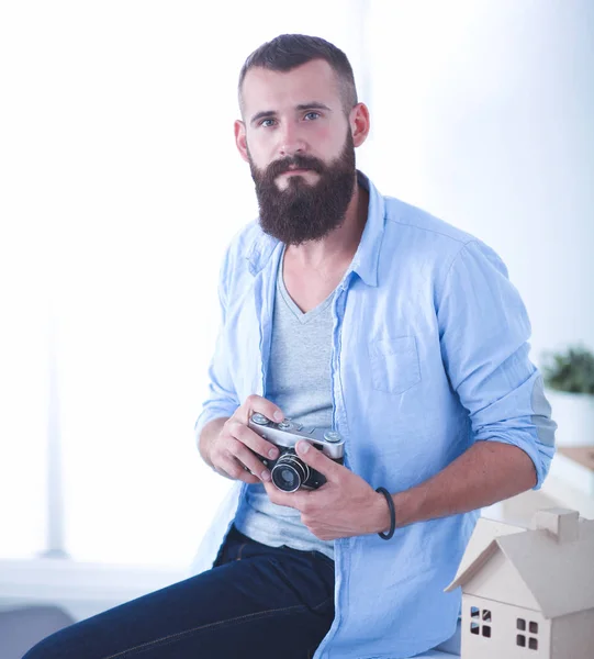 Portrait of male designer in hat with blueprints at desk — Stock Photo, Image