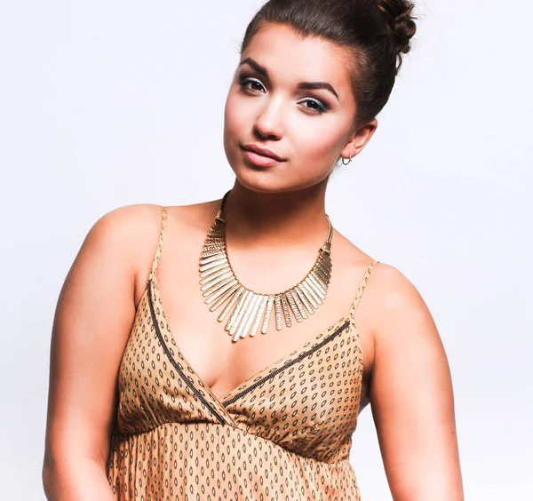 Young woman wearing a beige dress standing — Stock Photo, Image