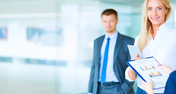 Portrait of young businesswoman in office with colleagues in the background — Stock Photo, Image