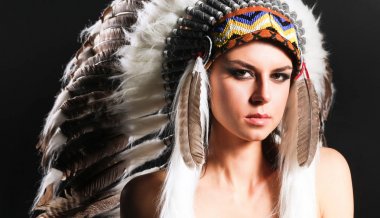 Beautiful woman in native american costume with feathers clipart