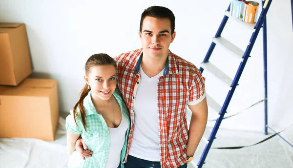 Young couple happy in their new modern design house showing thumbs up — Stock Photo, Image