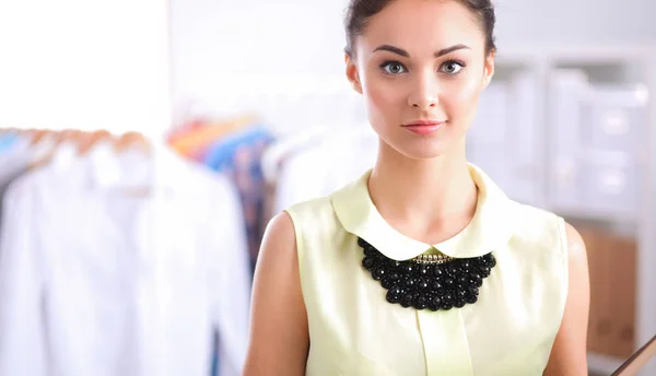 Young fashion designer working at studio , standing with folder — Stock Photo, Image