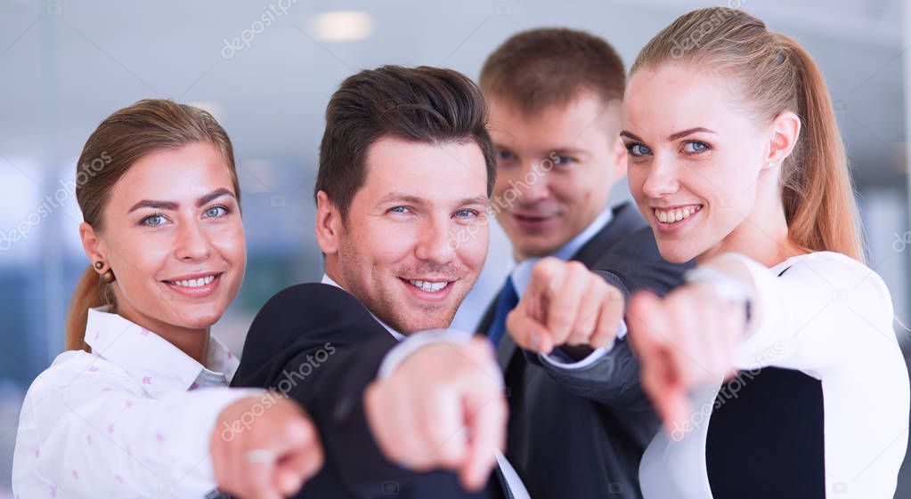 Group of business people pointing to you