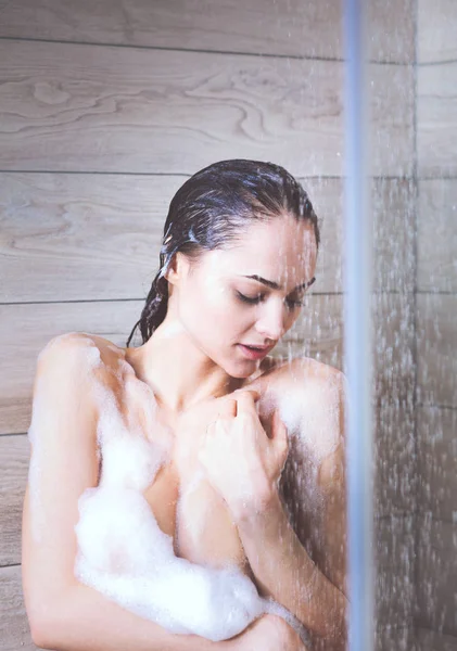 Jovem mulher bonita sob o chuveiro no banheiro . — Fotografia de Stock