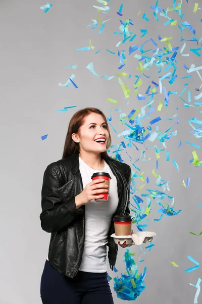 Beautiful happy woman with coffee at celebration party with confetti . Birthday or New Year eve celebrating concept — Stock Photo, Image