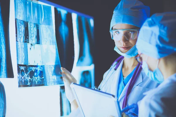 Two female women medical doctors looking at x-rays in a hospital. — Stock Photo, Image